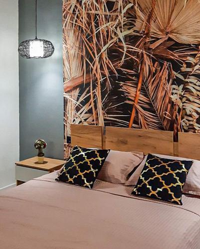 a bedroom with a bed with two pillows on it at Villa Bonapart in Zatoka