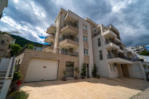 a large apartment building with a garage at Sun and Sea Apartments in Budva