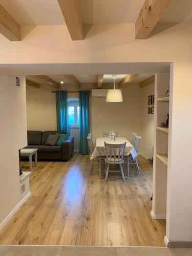 a dining room and living room with a table and chairs at Holiday home Ana in Cres