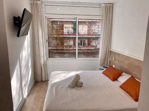 a bedroom with a bed with a stuffed animal on it at BcnStop Sagrada Familia in Barcelona