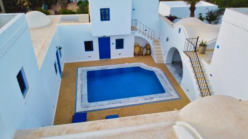 an aerial view of a house with a swimming pool at Villa Jasmin in Houmt Souk