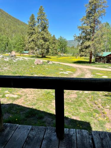 a view of a field from a wooden porch at Beyul Retreat in Meredith
