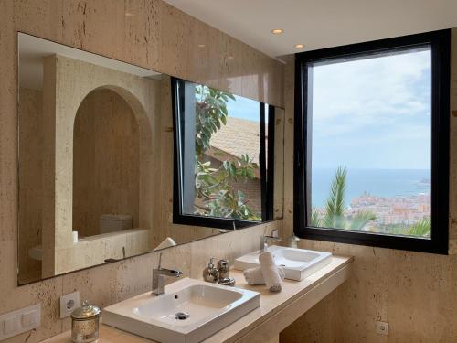 a bathroom with two sinks and a large mirror at Sitges Spaces Sea View Villa- 6 Bedrooms, 5 bathrooms, 2 private pools, Near center in Sitges