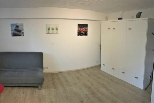a living room with a couch and a cabinet at Gehobene Studentenwohnung in Allensbach