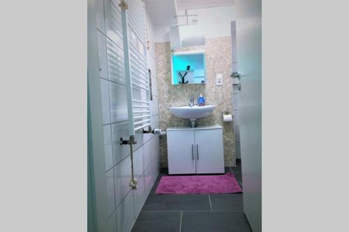 a bathroom with a sink and a mirror at Gehobene Studentenwohnung in Allensbach
