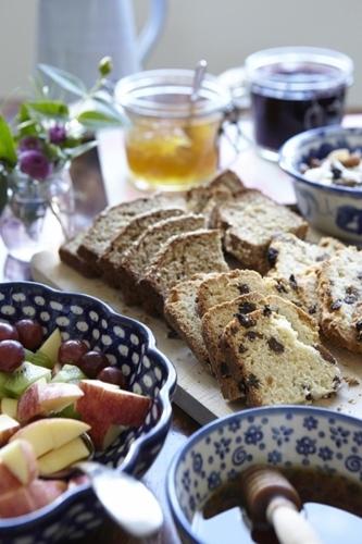 a table topped with plates of bread and grapes and grapesuggest at The Stop in Galway