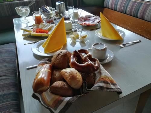 a table with a tray of bread and other foods at Hotel Waldhaus in Bodenmais