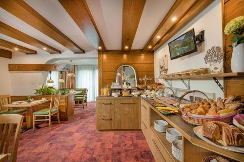a kitchen with wooden walls and a table with food on it at Pension Maria in Bad Hofgastein