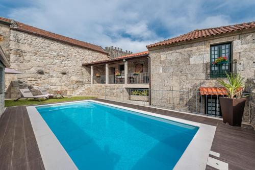 a swimming pool in the backyard of a house at Private Nature Villa with Saltwater Pool in North Portugal in Cabeceiras de Basto