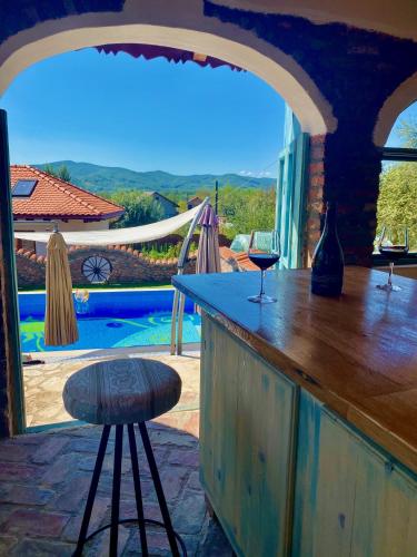 a bar with a view of a swimming pool at Conacul Grigorescu in Răteşti