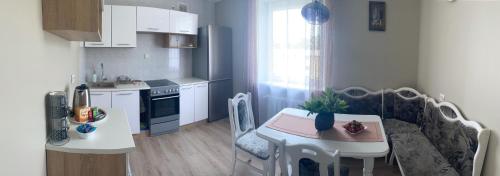 a small kitchen with a small table and a small kitchen with a kitchen at Holiday Apartments 10 in Druskininkai