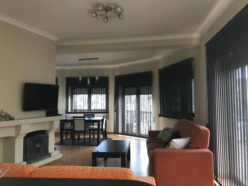 a living room with a couch and a table at Viriato Central House in Viseu