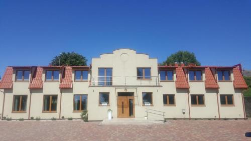 a large white building with a red roof at Willa Maciejka in Gdańsk