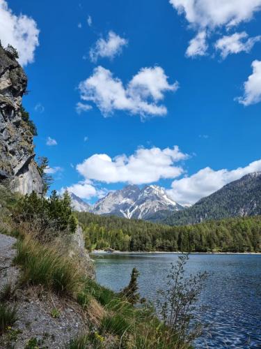 a view of a lake with mountains in the background at Alpenlandhaus Alte Schule in Lermoos