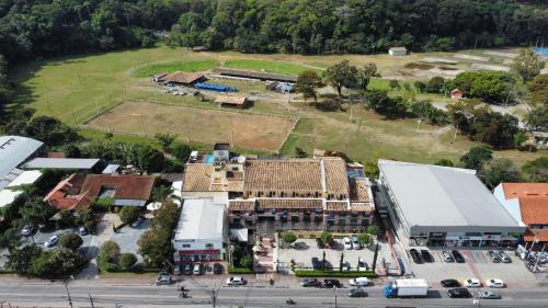 an aerial view of a building with a parking lot at Kastel Itaipava in Itaipava