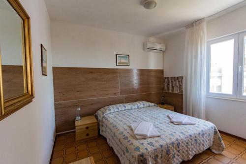 מיטה או מיטות בחדר ב-Hotel Calipso