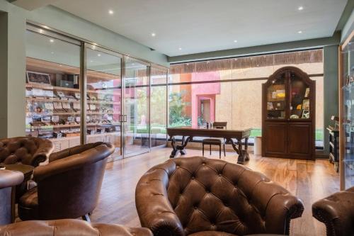 a living room with a pool table and leather chairs at Iberostar Waves Tucan - All Inclusive in Playa del Carmen