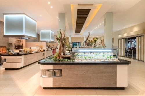 a kitchen with a food counter in a building at Iberostar Waves Tucan - All Inclusive in Playa del Carmen