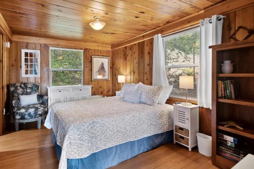 1 dormitorio con 1 cama, 1 silla y 1 ventana en Lakeside Loungin', en Hayden