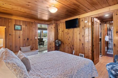 a bedroom with a bed and a flat screen tv at Lakeside Loungin' in Hayden
