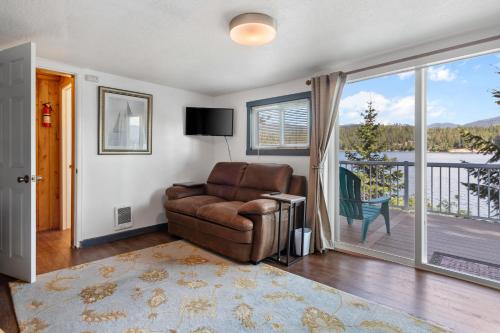 a living room with a leather chair and a balcony at Lakeside Loungin' in Hayden