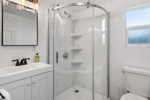 a white bathroom with a shower and a sink at Lakeside Loungin' in Hayden