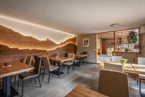 a restaurant with wooden tables and chairs at Tourist Farm Kranjc in Kobarid