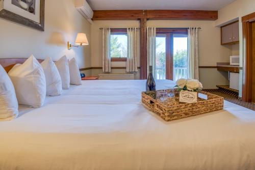 a large bed in a hotel room with a tray of flowers on it at Purity Spring Resort in Madison