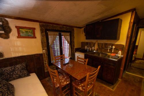 a kitchen with a table and a kitchen with a sink at Smeštaj Popović in Perućac