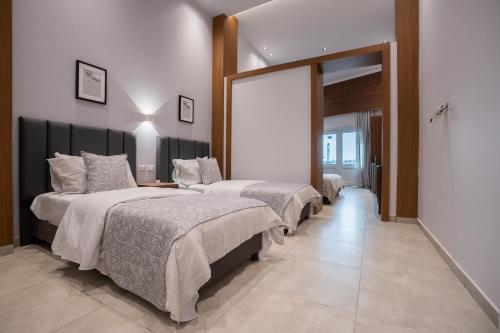 two beds in a room with a hallway at Sea Gull Marina Hotel in El Alamein