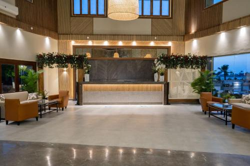 a lobby of a hotel with tables and chairs at Sea Gull Marina Hotel in El Alamein