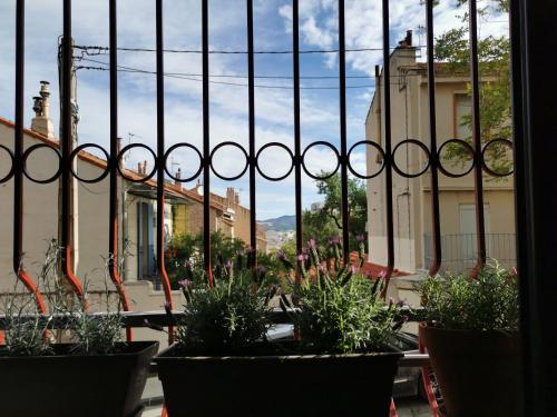 a view from a balcony with plants in pots at Studio calme et très lumineux, au pied de notre Dame de la Garde in Marseille