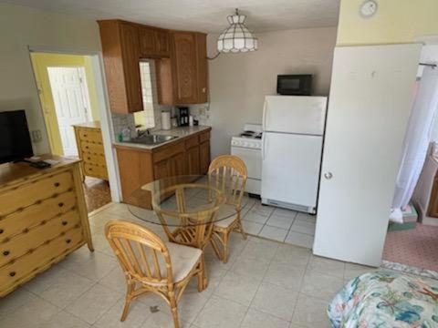 a kitchen with a table and chairs and a kitchen with a refrigerator at Coconut Cove Resort & Marina in Islamorada