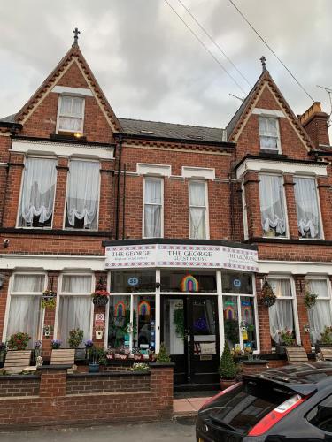 a brick building with a store in front of it at The George Guest House in Bridlington