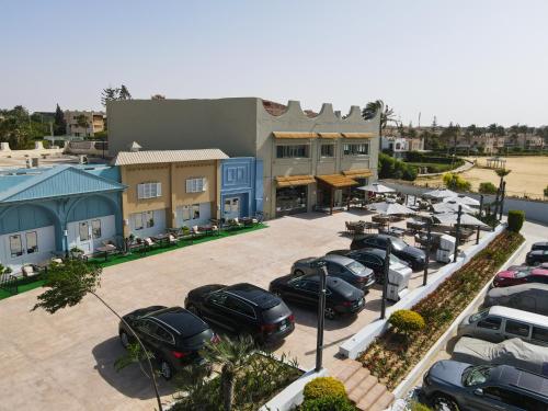 an aerial view of a parking lot with cars parked at Sea Gull Marina Hotel in El Alamein