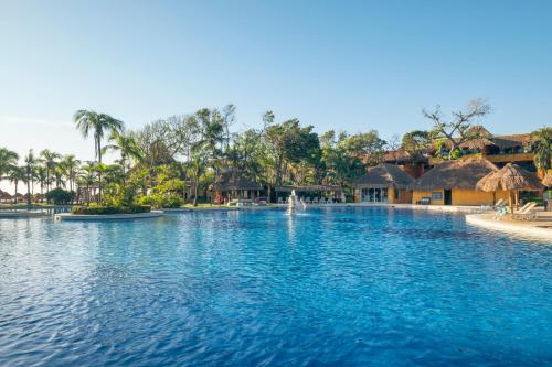 a swimming pool at a resort with a fountain at Iberostar Waves Tucan - All Inclusive in Playa del Carmen