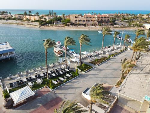 an aerial view of a resort with palm trees and a beach at Sea Gull Marina Hotel in El Alamein