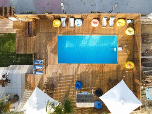 an overhead view of a swimming pool with umbrellas at Sea Gull Marina Hotel in El Alamein