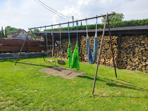 a group of swings in a yard with a building at West Bohemian Home, Krajkova 208 in Krajková