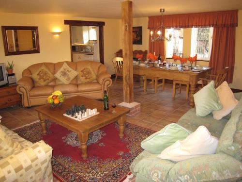 a living room with two couches and a dining room at Colston Hall Cottages in Framlingham