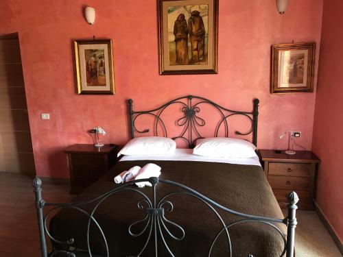 a bedroom with a bed in a red wall at Villa Scotillo Boutique Hotel in Agropoli