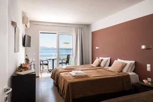 A bed or beds in a room at Pantokrator Hotel