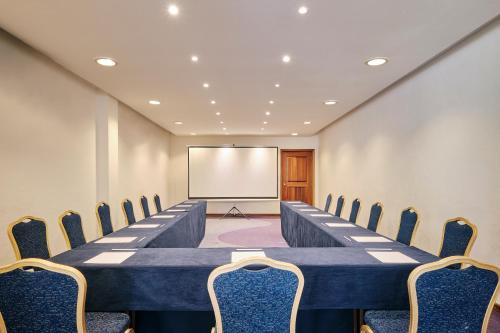 a long table and chairs in a room with a whiteboard at Iberostar Waves Tucan - All Inclusive in Playa del Carmen