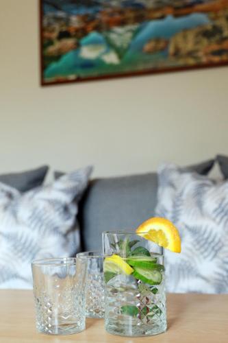 two glasses of water and an orange slice on a table at Penzion Bawaria in Horní Lomná