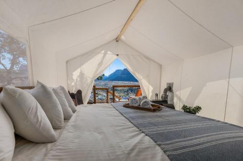 a large white bed in a white tent at Under Canvas Zion in Virgin