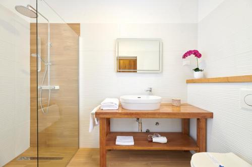 a bathroom with a sink and a shower at Sobe Sole in Umag