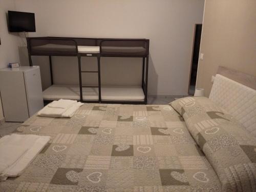 a bedroom with a bed and a bunk bed at IL CONTE DI MARRAONE in Agnone