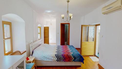 a bedroom with a bed with a colorful comforter at Dream Catcher Villa - Beachfront & Seaview terrace in Prčanj