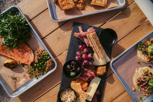 three plates of food on a wooden table at Under Canvas Zion in Virgin