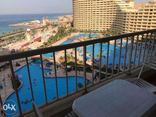 a view of a pool from a balcony of a resort at Porto sokhna Pyramids family only in Al Ḩafāʼir